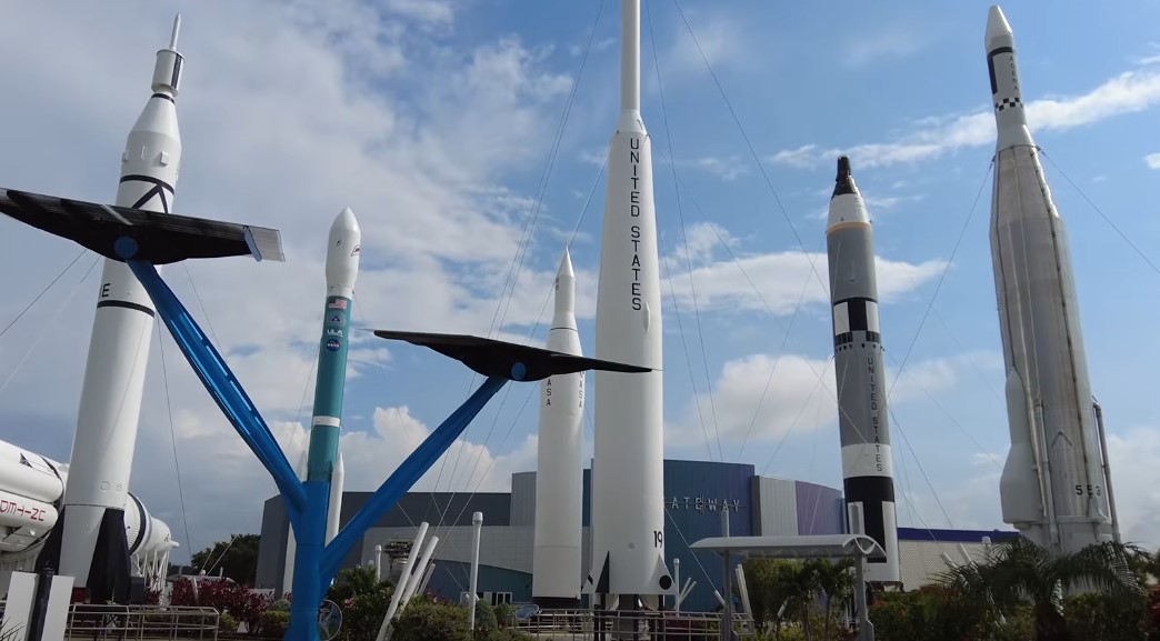 Several impressive rockets stand tall against a partly cloudy sky