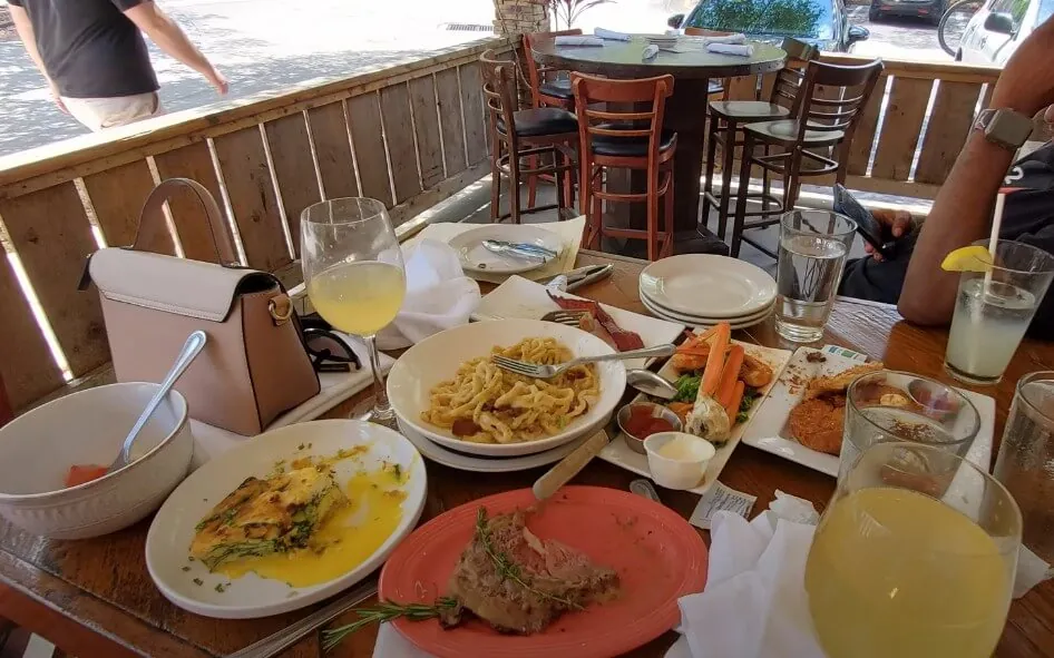 Outdoor dining scene, filled with various dishes and drinks