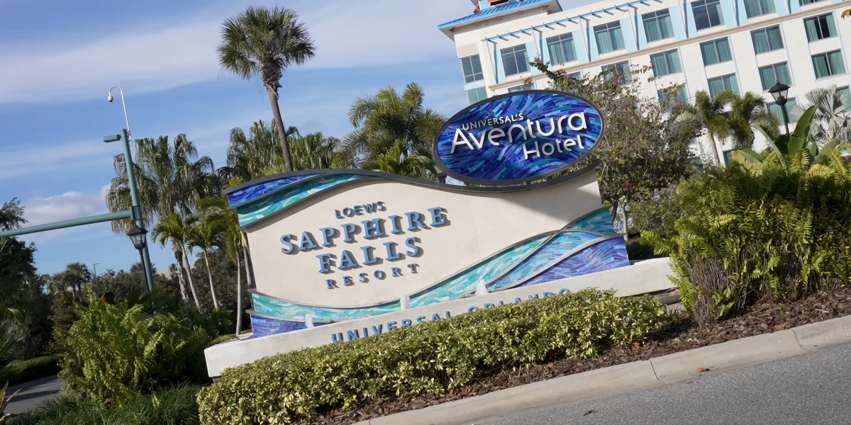 The entrance sign for Loews Sapphire Falls Resort and Universal’s Aventura Hotel