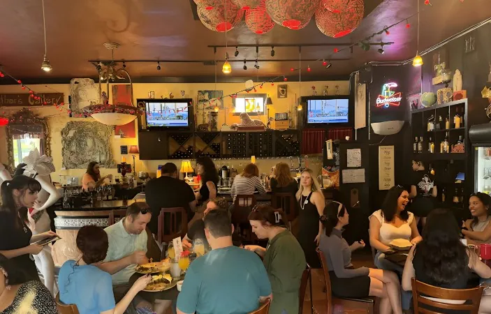 Lively atmosphere in a bustling restaurant, filled with diners enjoying a meal