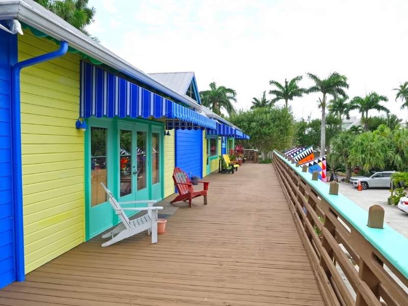 Colorful beach cottages along wooden deck